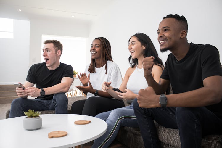 Group Of Friends Watching TV On C