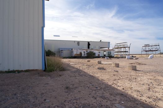 Deserted industrial building in Arizona under a clear blue sky, showcasing signs of neglect.