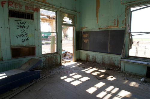 Free An abandoned classroom with graffiti and peeling paint, symbolizing decay and neglect. Stock Photo