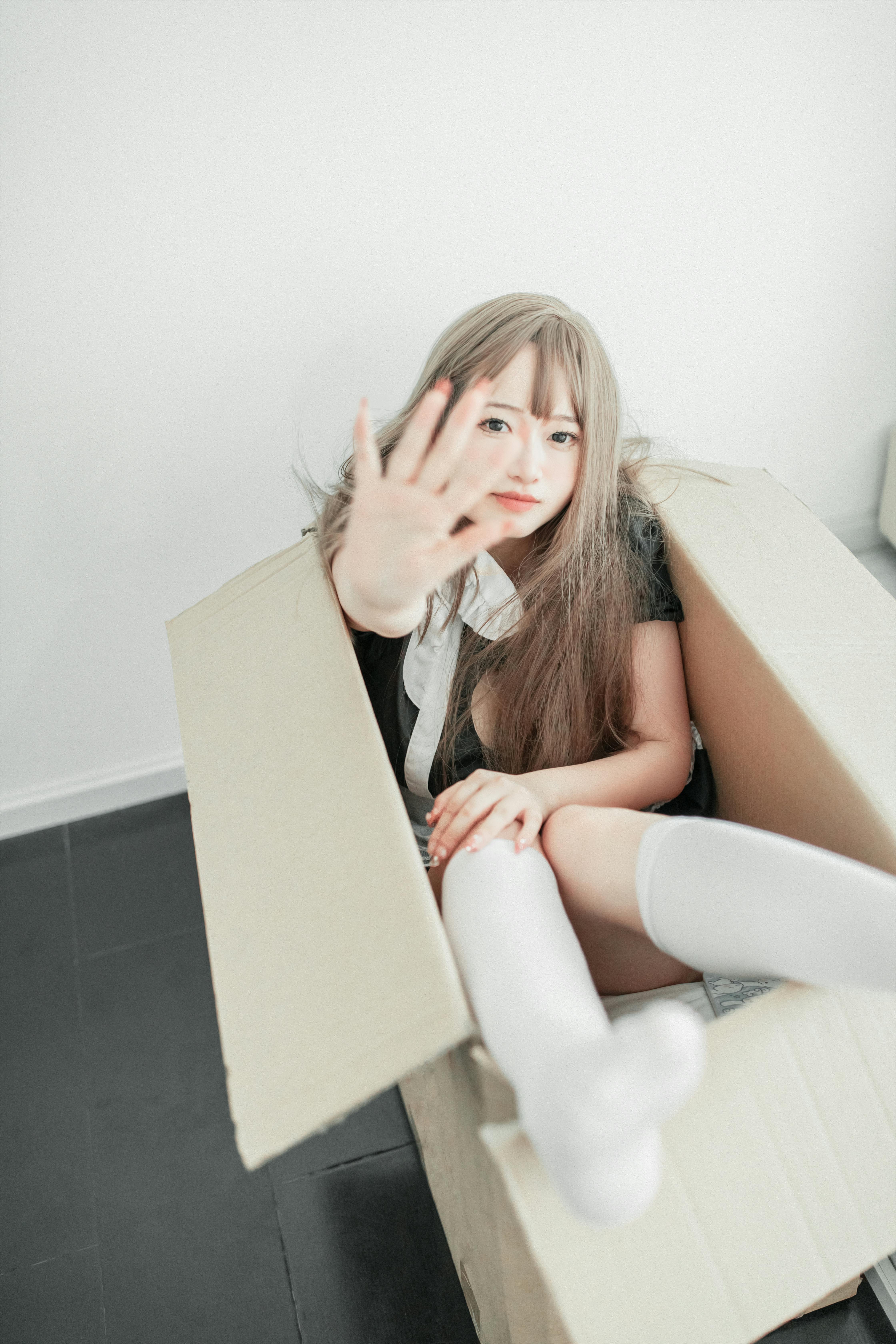 a woman sitting inside the box