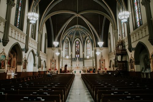 Free Stunning view of a Gothic cathedral's interior with arches and stained glass. Stock Photo