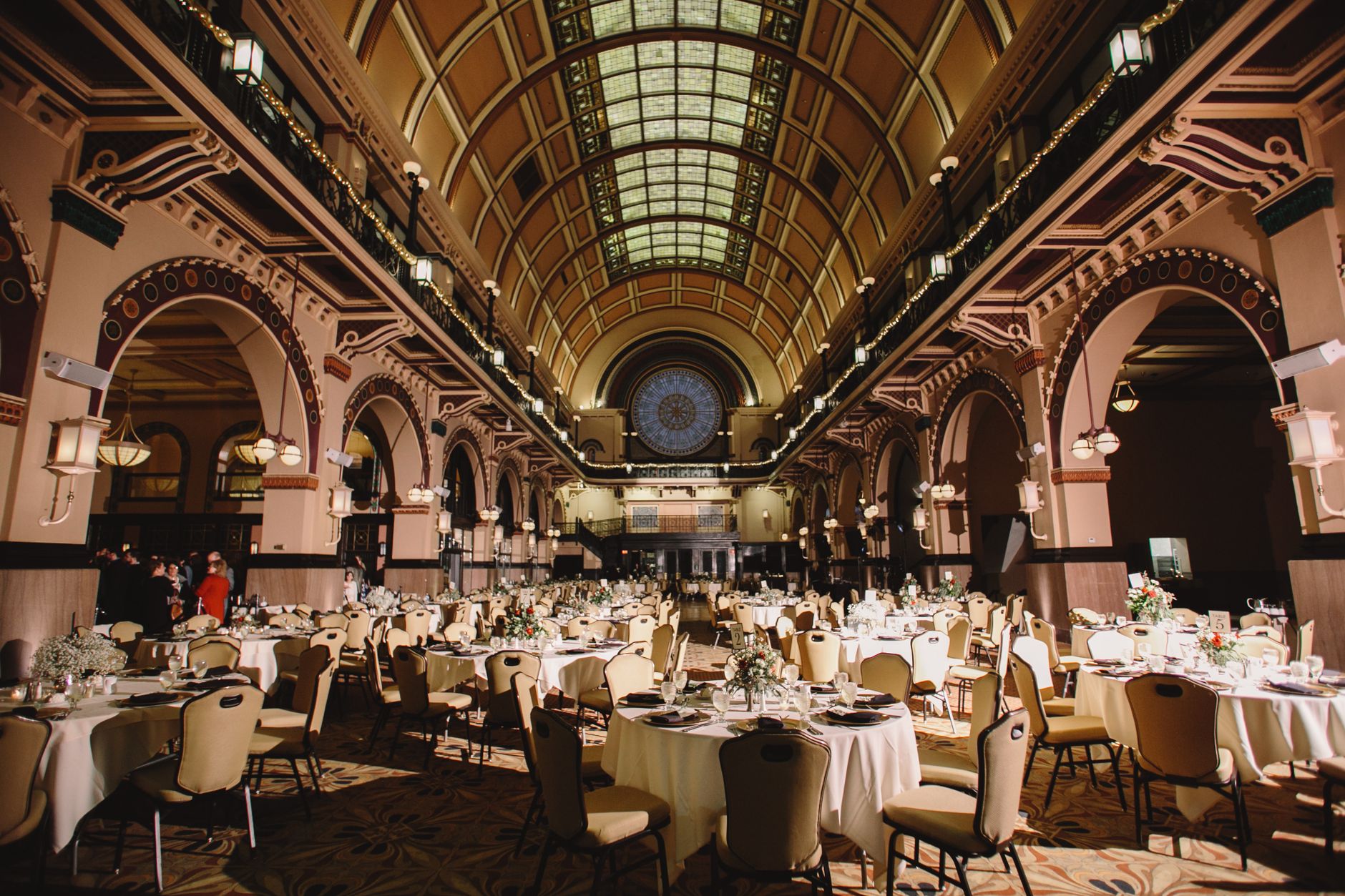A beautifully set banquet hall with ornate architecture and ambient lighting ideal for formal events.