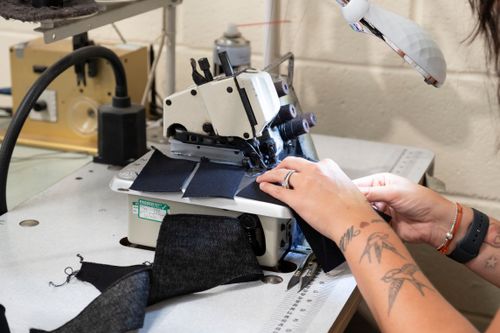 Free Close-up shot of a seamstress using a sewing machine, focusing on hands and fabric. Stock Photo
