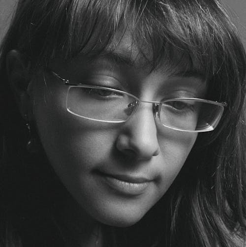 A Woman Wearing Silver Framed Eyeglasses