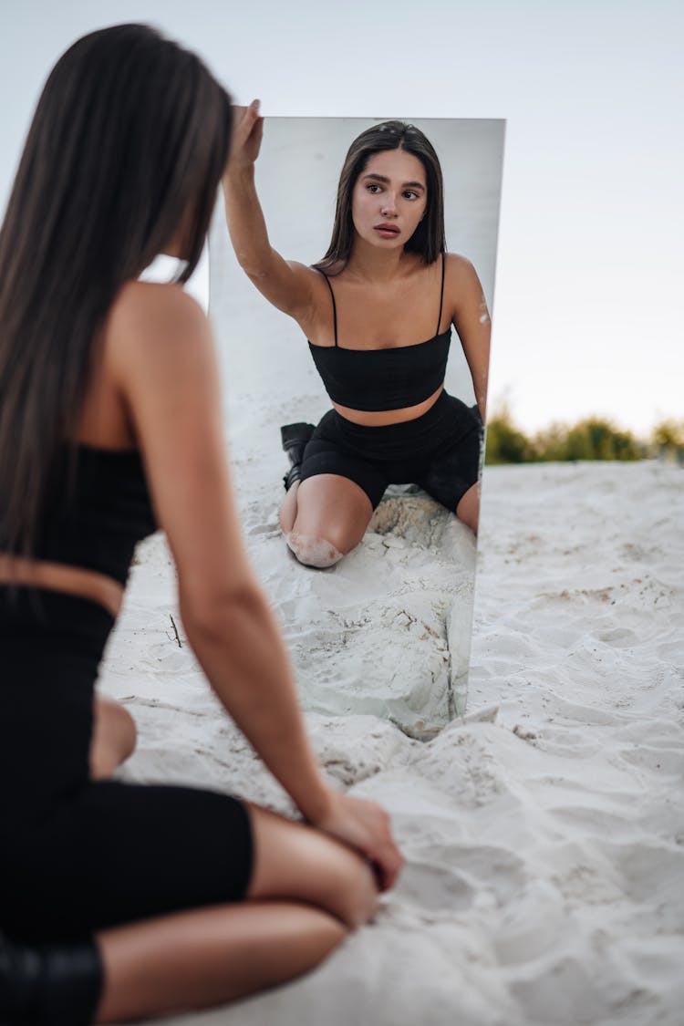 Woman With Mirror On Beach