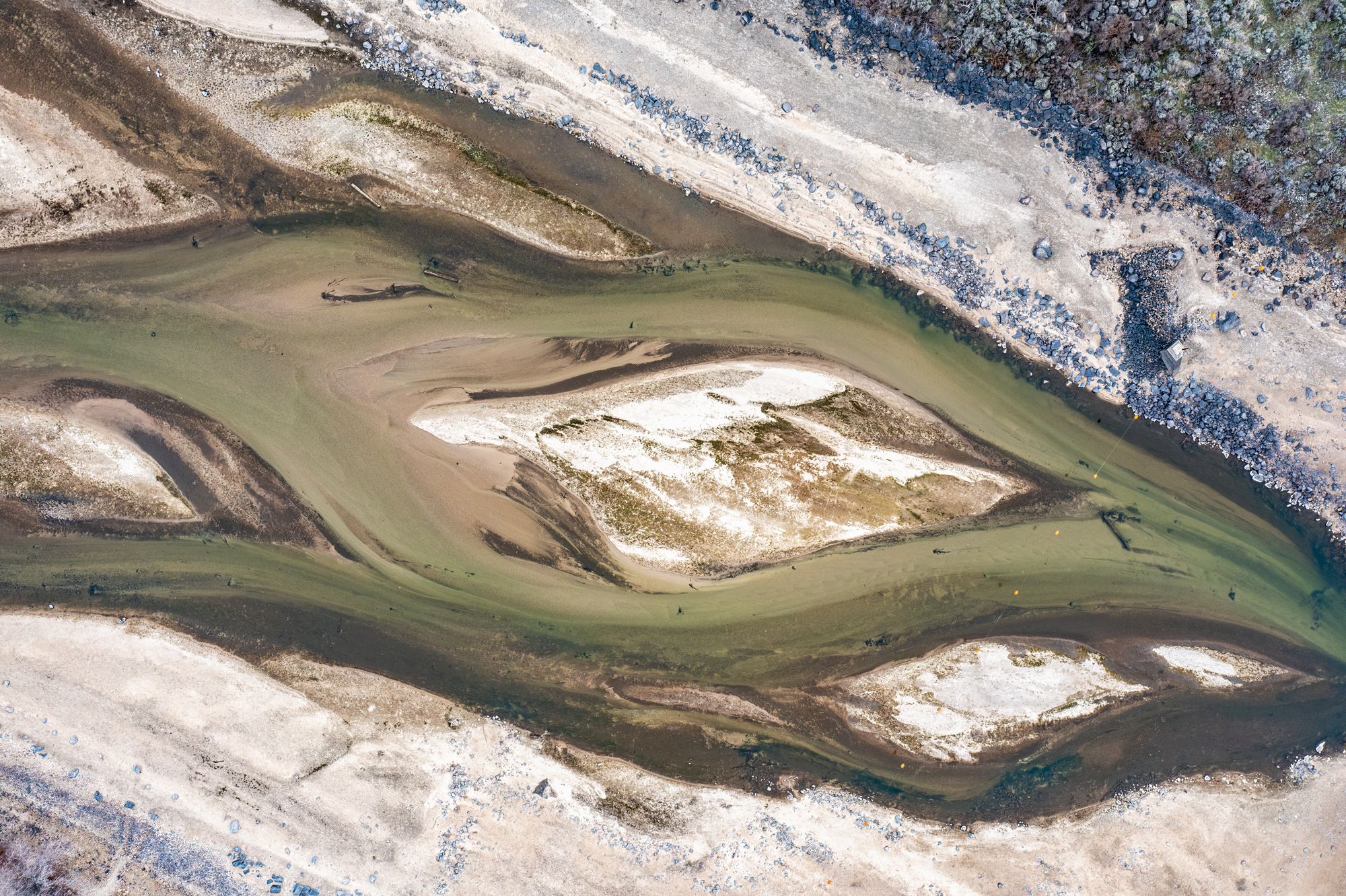 A stunning aerial view of a river with sandbanks creating unique patterns in a natural landscape.