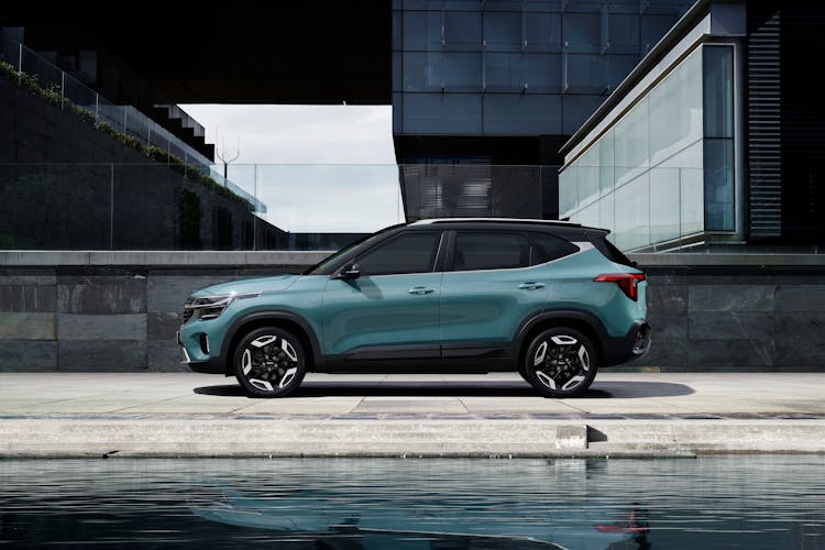 Green And Black Car Near Modern Building