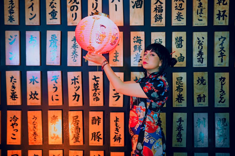 A Woman In Floral Kimono Holding A Lantern