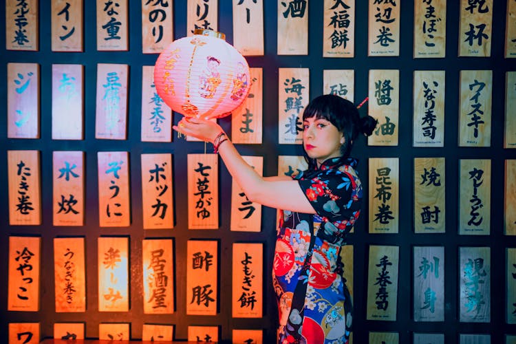 A Woman In Floral Kimono Holding A Japanese Lantern