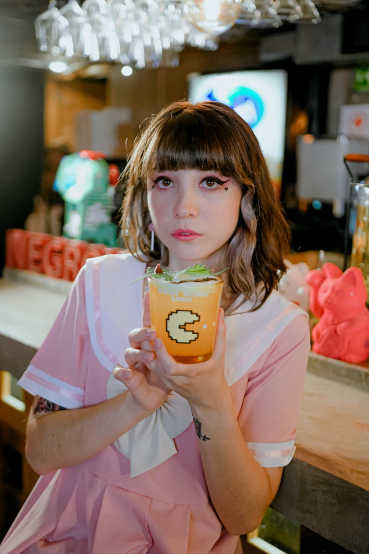 A Woman Holding A Glass With Cocktail Drink