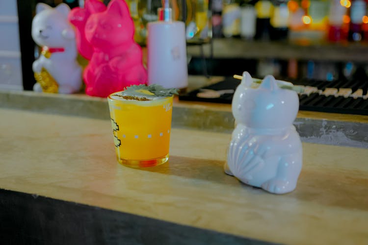 Drink On A Bar Counter And Maneki Neko Figurines