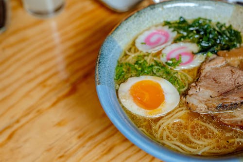 Soup with Egg and Meat in Ceramic Bowl