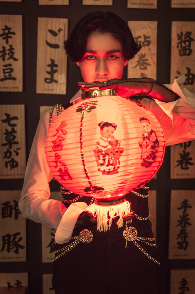 Person Holding Red Ball Lantern