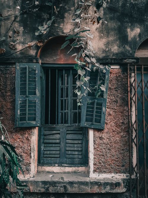 Free Old colonial building window with wooden shutters, showcasing urban decay in Kolkata, India. Stock Photo