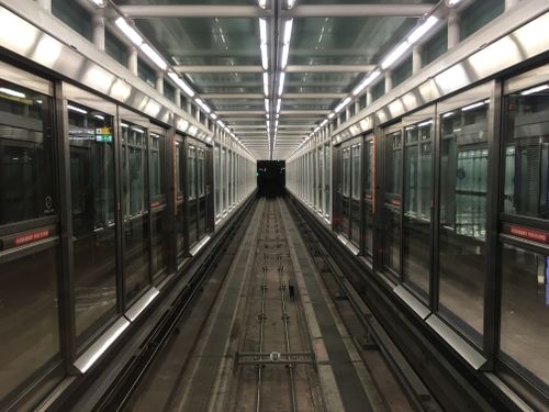 Free A modern, symmetrical train tunnel in a Washington DC airport terminal, showcasing transportation architecture. Stock Photo