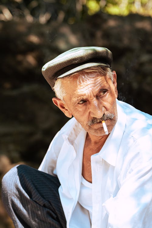 Photo of an Elderly Man Smoking Cigarette