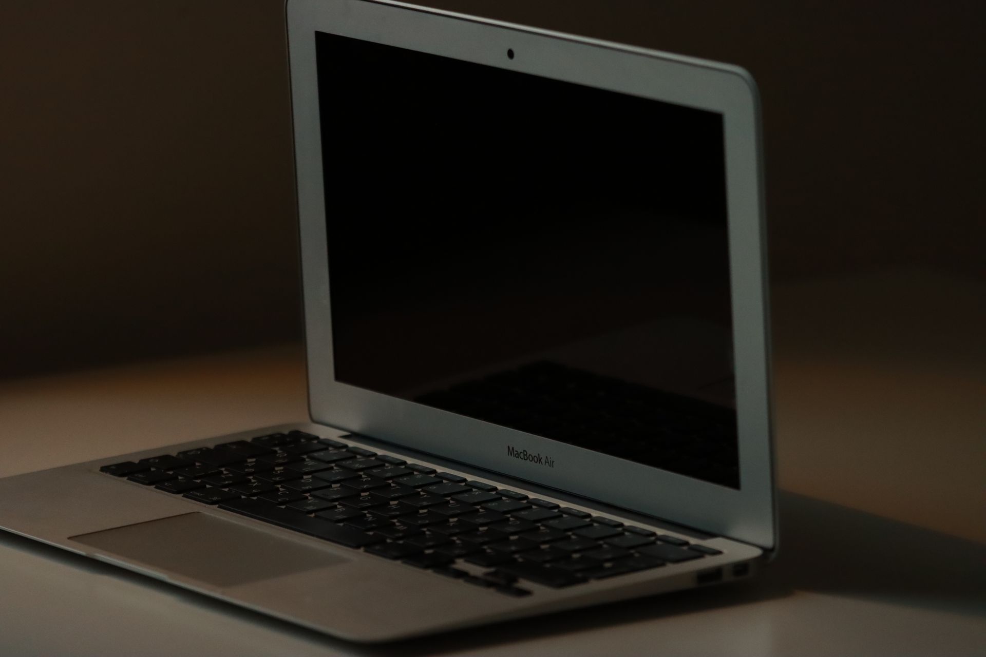 A clean and minimalist close-up of a MacBook Air on a desk, perfect for tech and lifestyle themes.