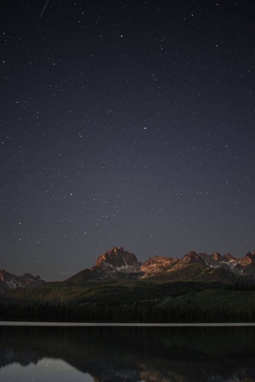 Stars over a mountain ridge at night — Ryan Leeper on Pexels