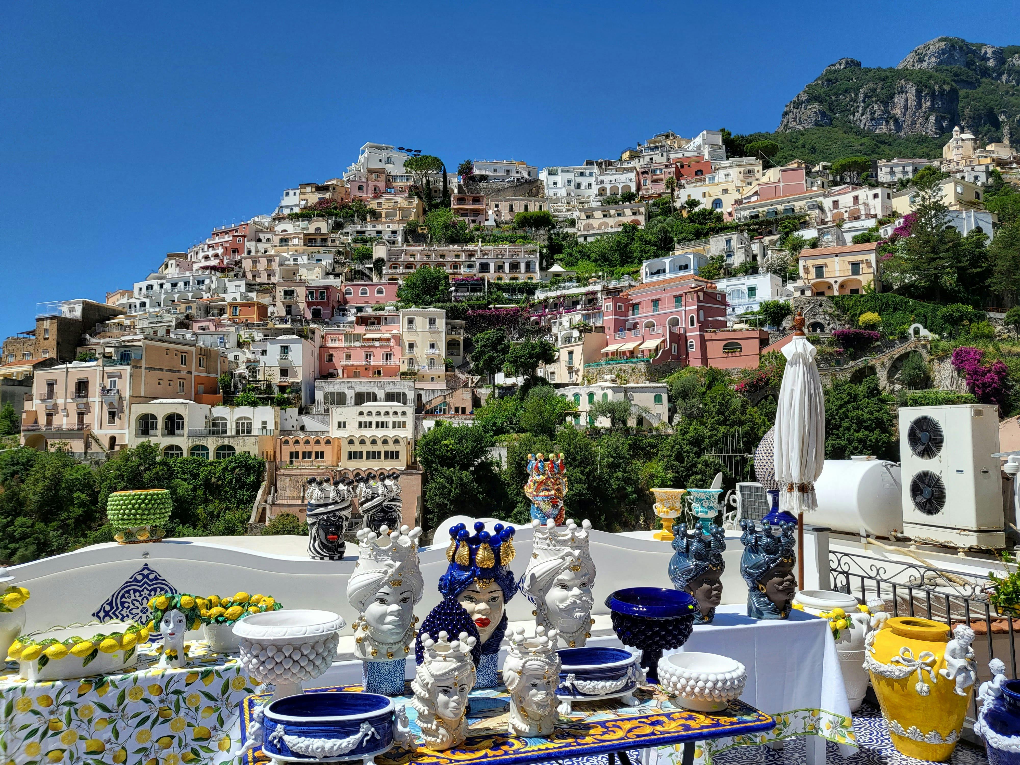 Figurines and Ceramic Bowls on Display · Free Stock Photo