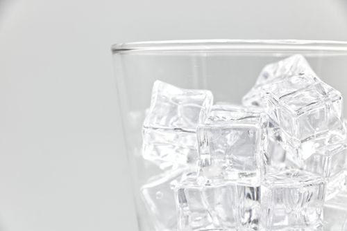 Free Refreshing close-up of ice cubes in a clear glass. Ideal for beverage and freshness themes. Stock Photo