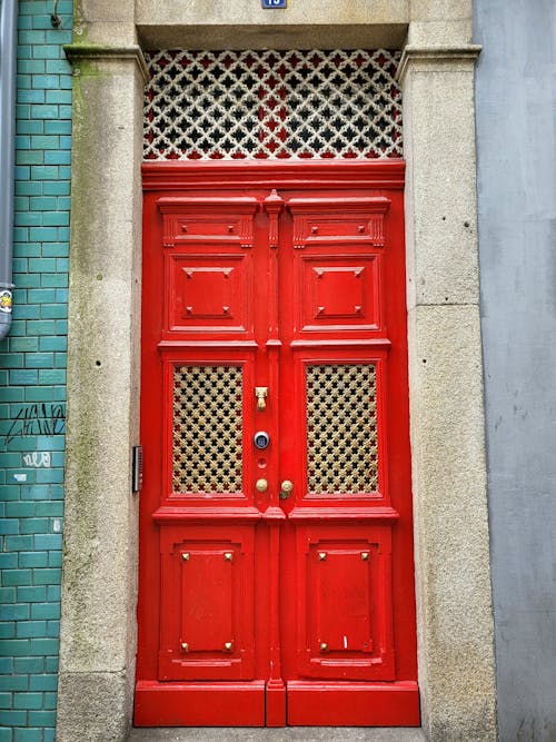Red Wooden Door on Gray Concrete Wall