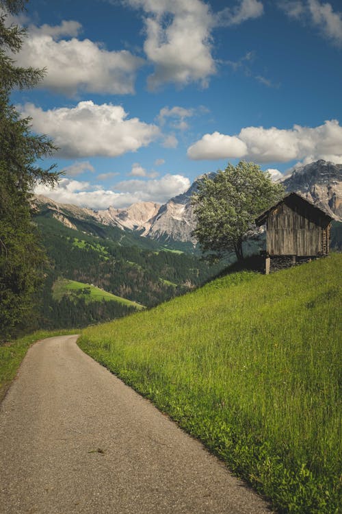 Mountain Landscape with a Barn and Clouds in Sky