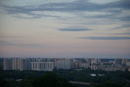 Aerial view of Kyiv's skyline with residential buildings at dusk, showcasing urban life.