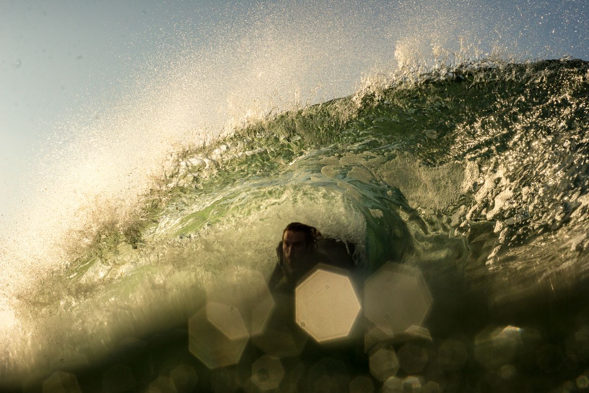 Surfer riding deep inside a hollow barrel wave — the type of wave Zicatela is famous for
