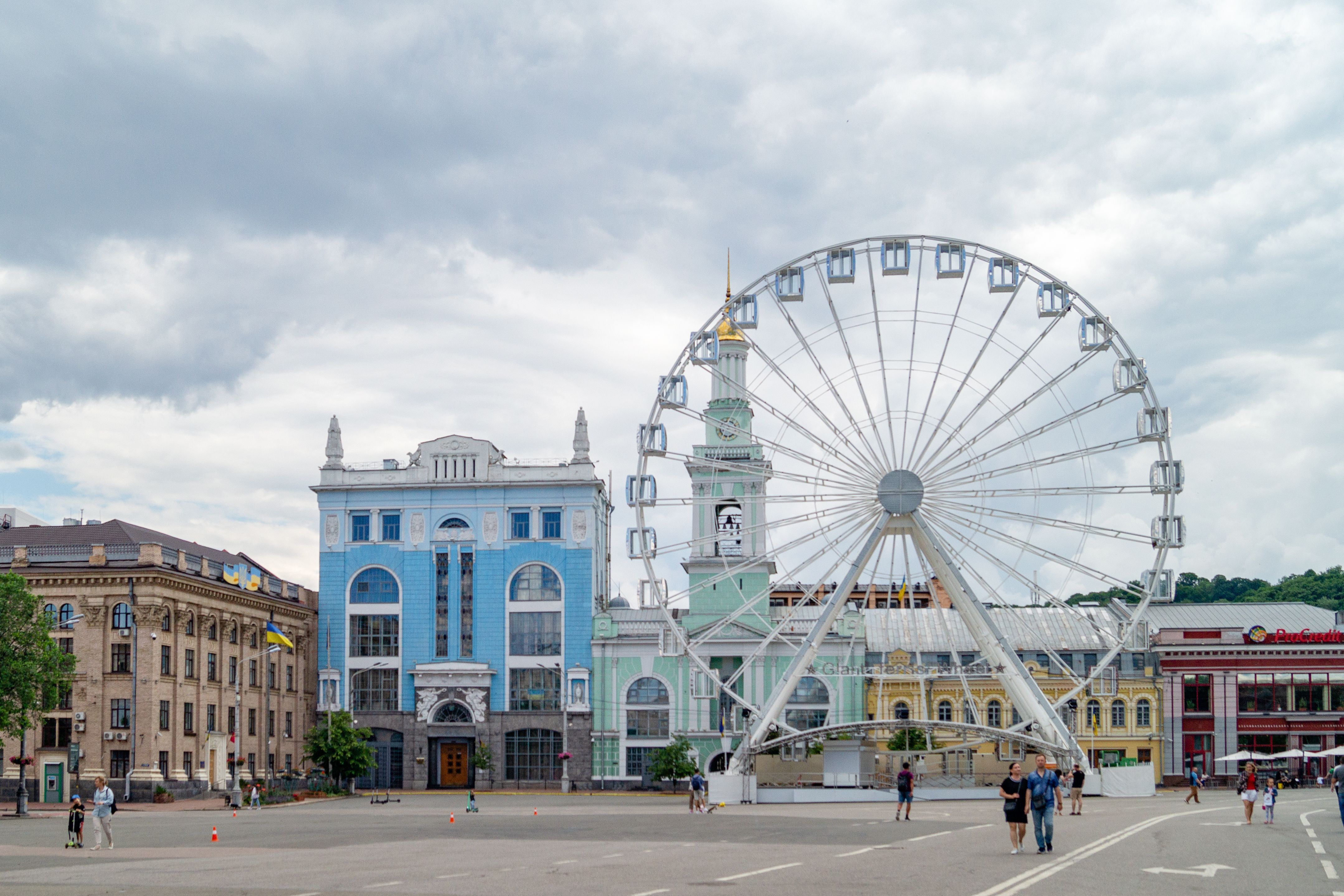 A Ferris wheel towering over the historic Podil district in Kyiv's city square, showcasing modern and traditional architecture. (Photo by Nadin Nandin on Pexels)