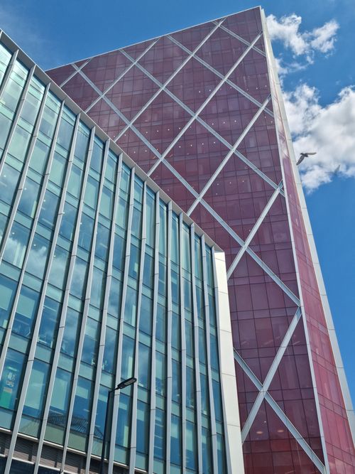 Free Low angle view of modern skyscraper facades with a clear blue sky background. Stock Photo