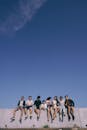 Group of Friends Sitting on a Concrete Fence
