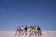 Group of People Sitting on Top of the Building