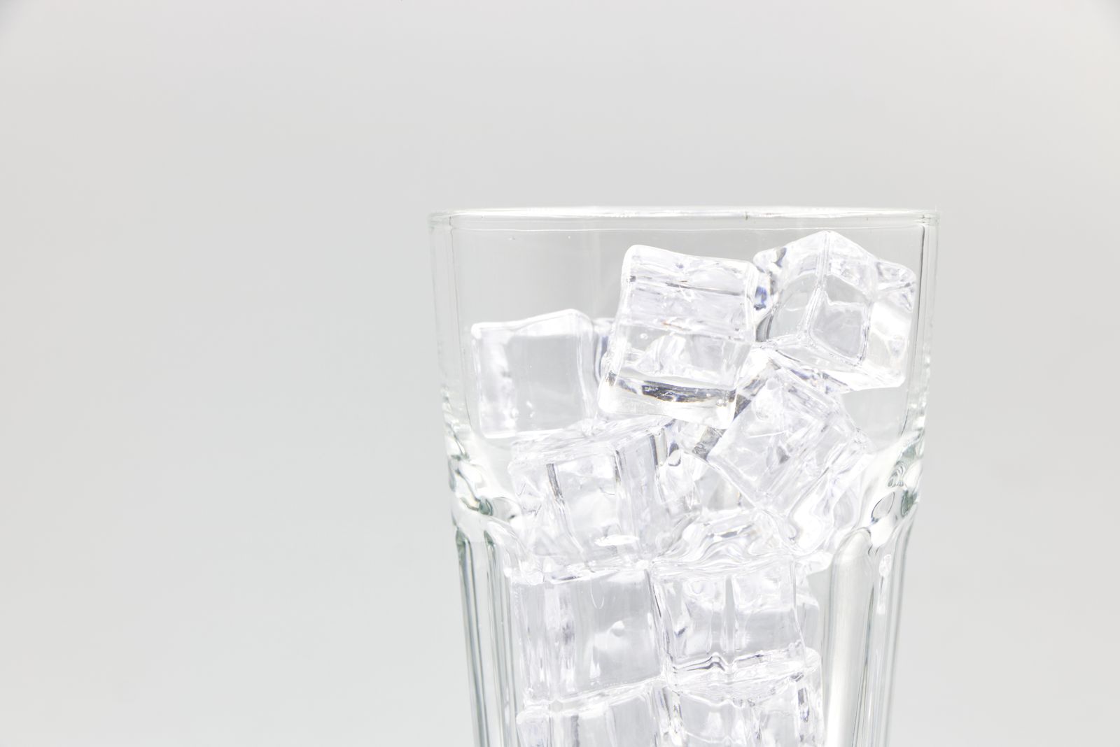 A glass filled with chewable nugget-style ice ready for a cocktail