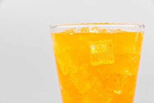 Free A Yellow Iced Drink in a Clear Drinking Glass Stock Photo