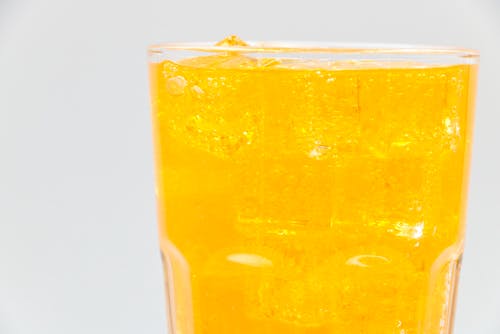 Free Clear Drinking Glass with Yellow Liquid Stock Photo