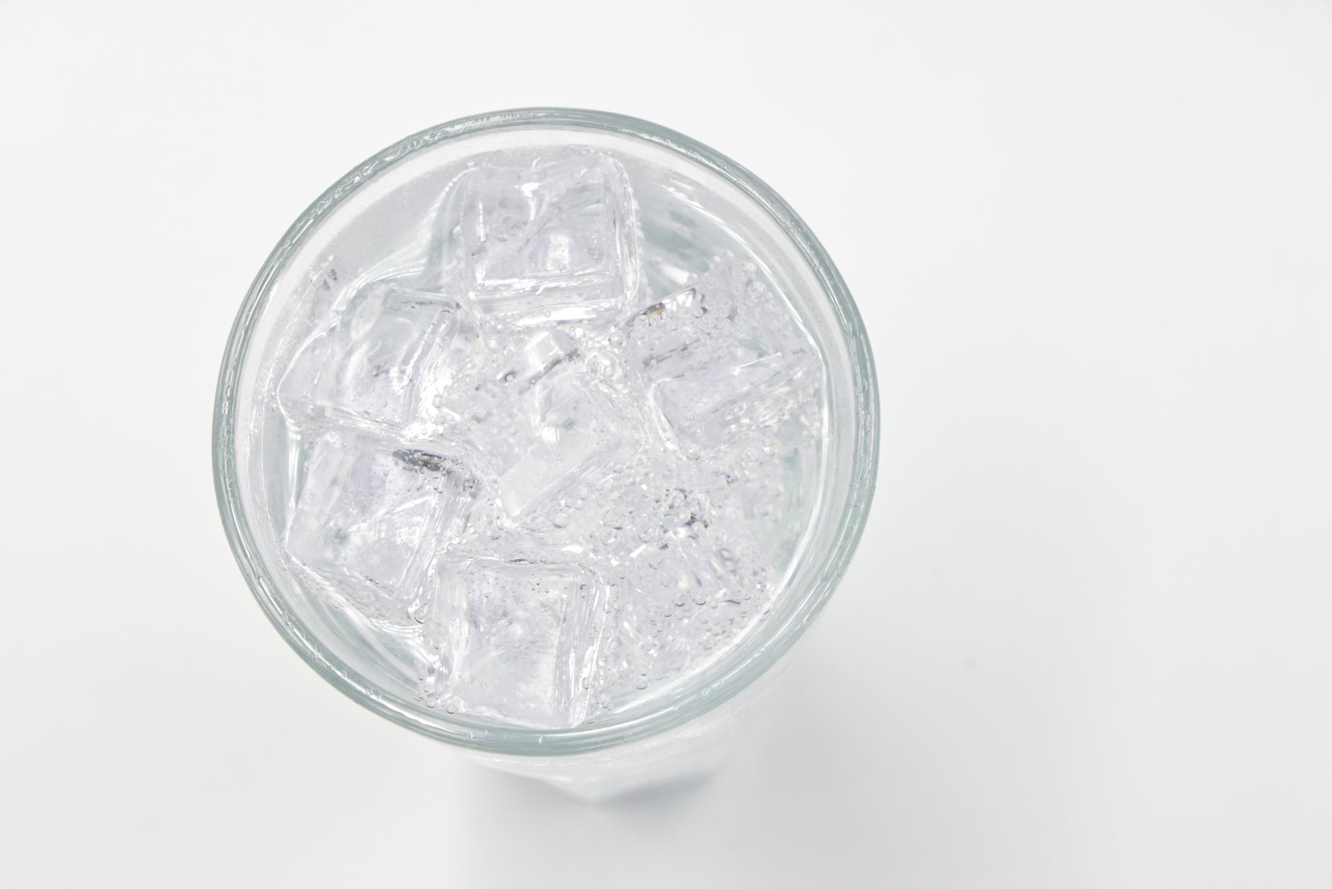Refreshing ice cubes in a glass on a white background, perfect for drink and lifestyle themes.