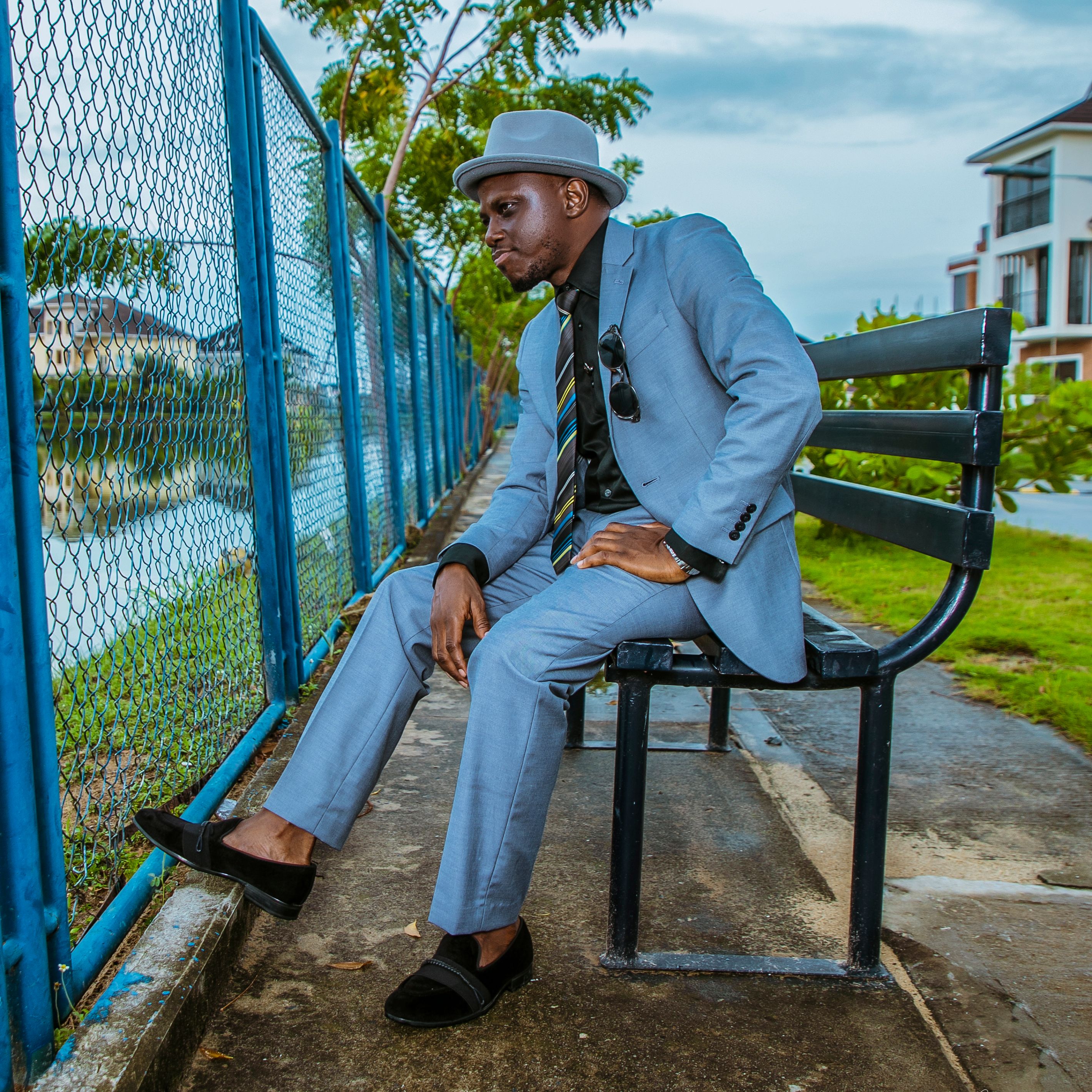 Man in Blue Suit Sitting on a Bench · Free Stock Photo