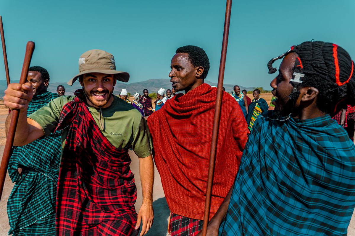 Maasai men in traditional red and black shukas standing together in Kenya