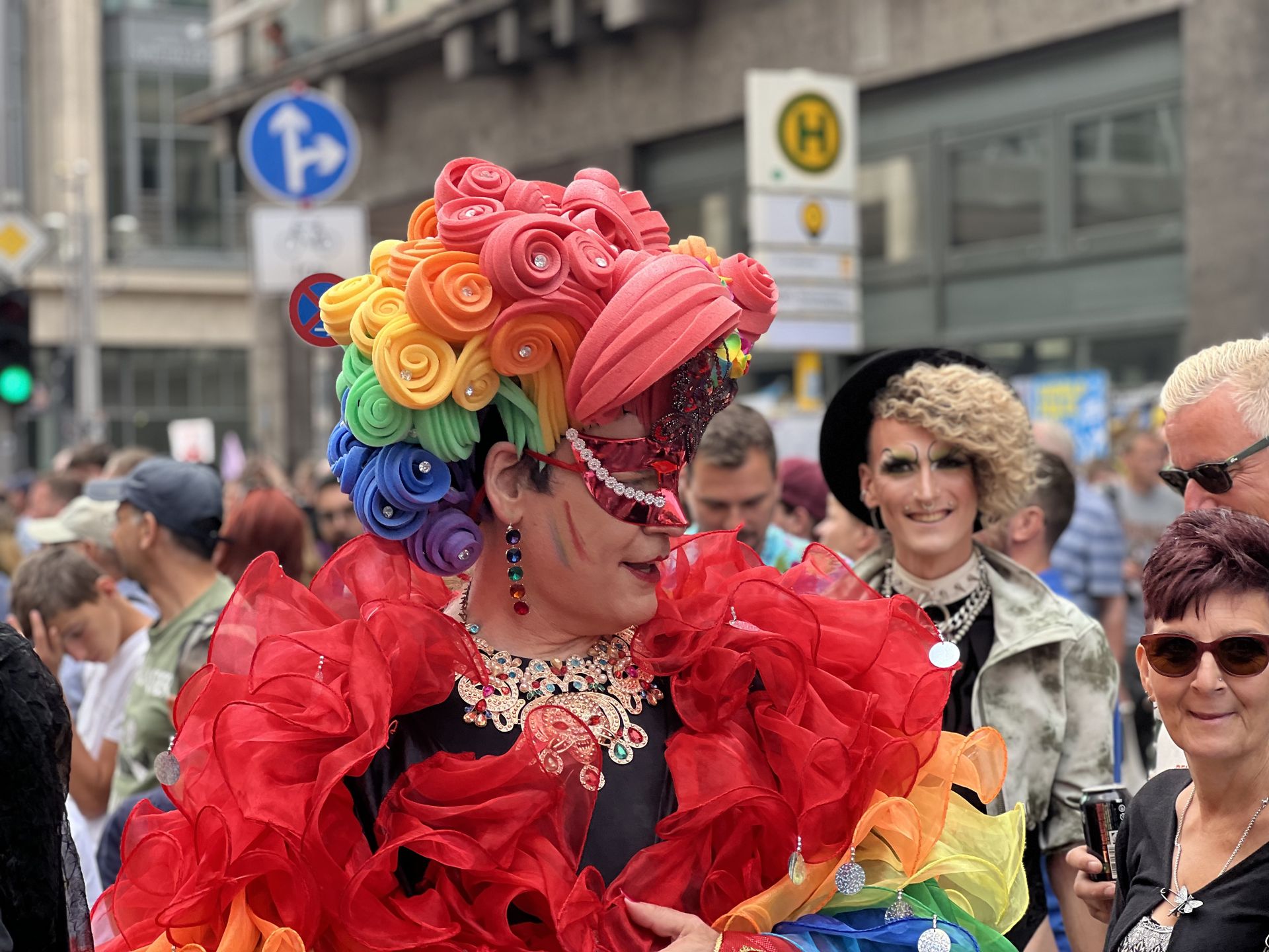 Vibrant drag performer in rainbow outfit at Berlin Pride Parade, showcasing LGBTQ+ celebration and diversity.
