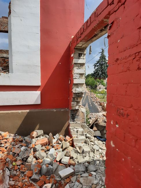 Photo by Анна Ерилина on Pexels A partially demolished building with red brick walls and debris in an urban setting in Kharkiv, Ukraine.