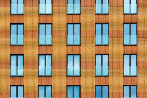 Free An Orange Brick Building with Glass Windows  Stock Photo