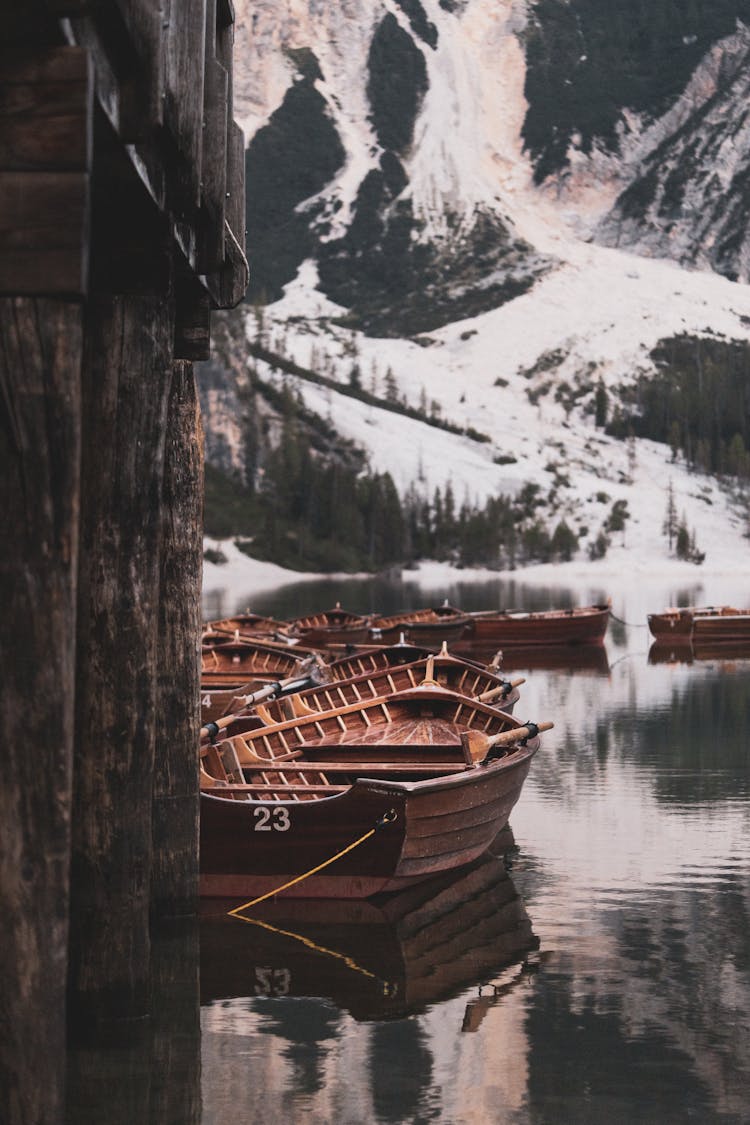 Row Of Boats Docked By Lake