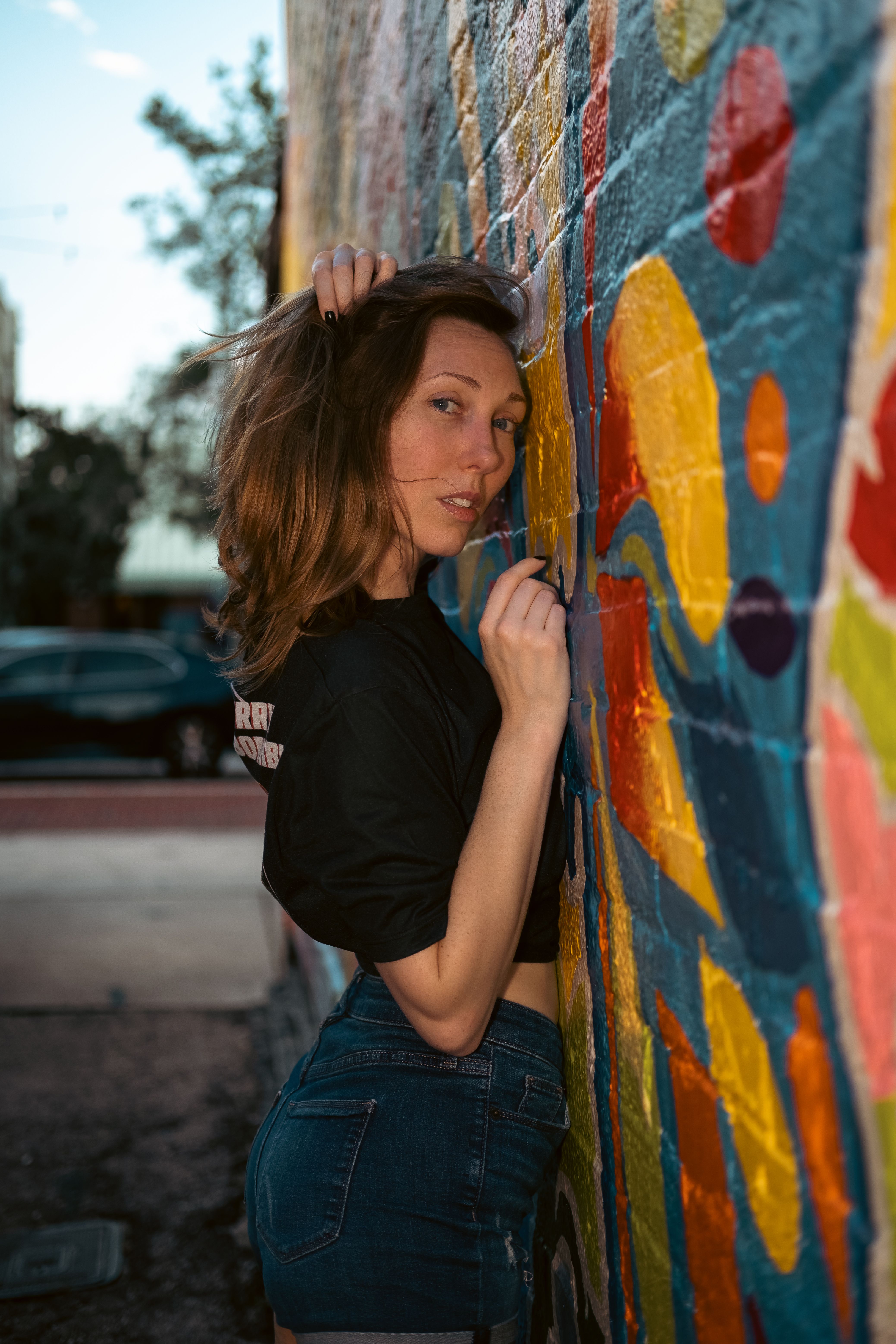 A Woman Leaning Against the Brick Wall · Free Stock Photo