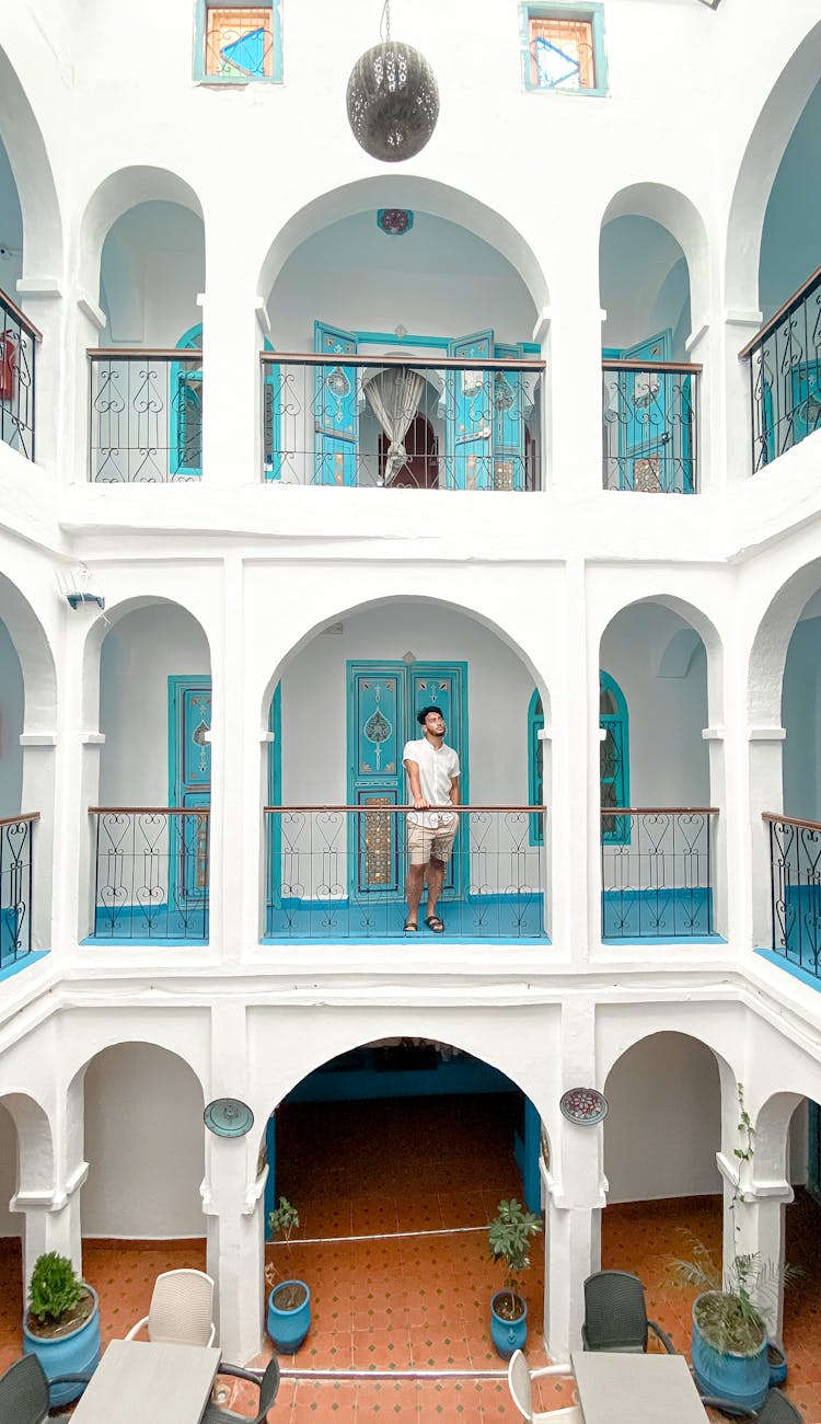 White Building With Arcades And Turquoise Doors