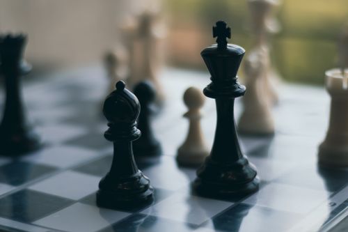 Free Close-up of chess pieces on a chessboard, emphasizing a strategic game setting. Stock Photo