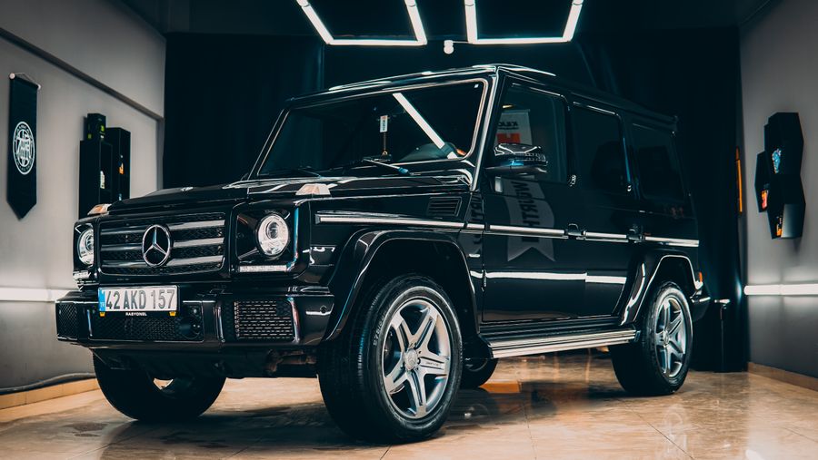 Black Mercedes-AMG G 63 in a dark showroom