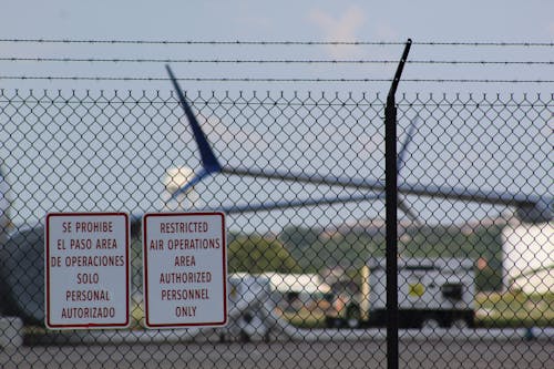 Signboards Hanging on Metal Fence