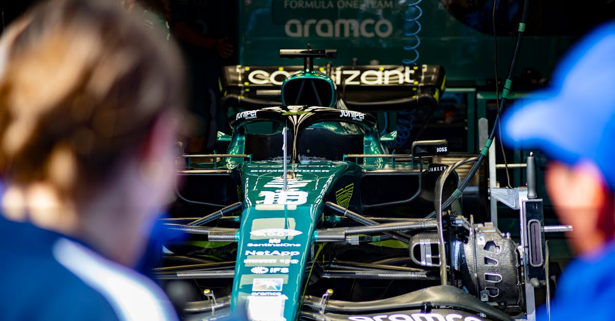 Aston Martin Formula 1 race car being prepared in the team garage before competition.