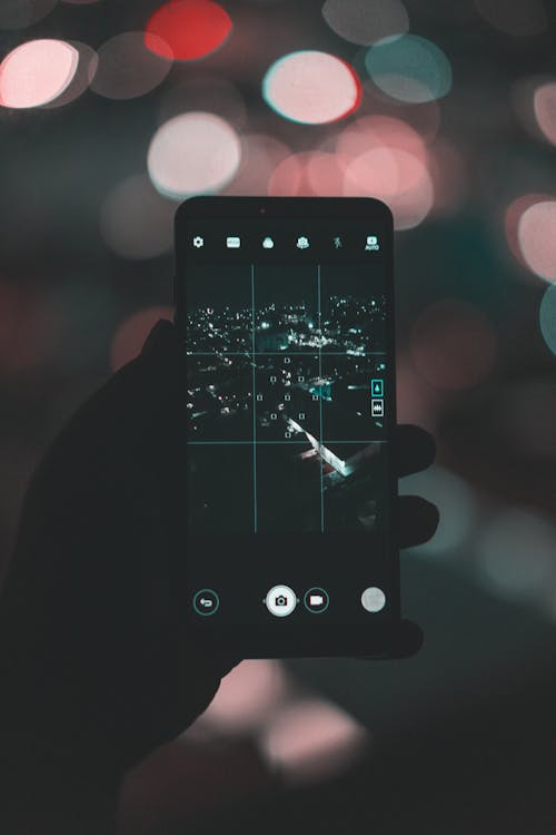 Free Photo of Person Taking Picture of City During Evening Stock Photo