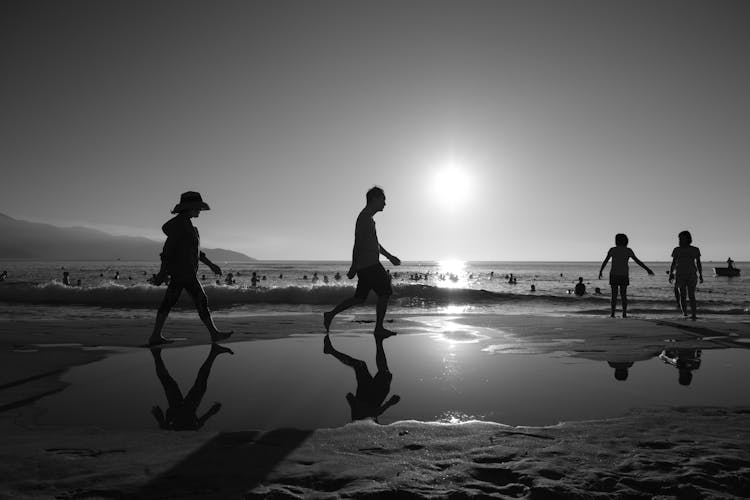 A Silhouette Of People At The Beach